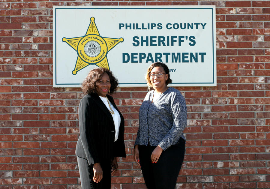 Ever Ford and Raneshia Ezell standing in front of Phillips County Sheriff's Office sign